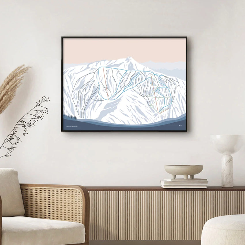 The Bridget Hall Designs Treble Cone Trail Map Print in a black frame above a console