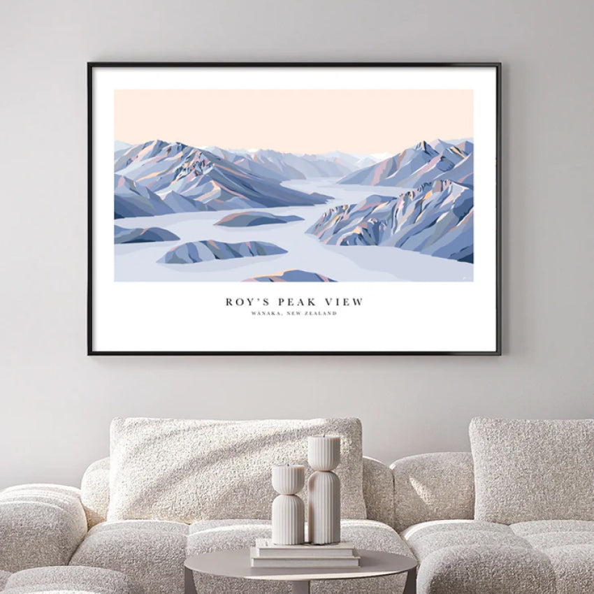 The Bridget Hall Designs Roys Peak View Art Print in a black frame above a couch