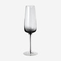The Broste Copenhagen Champagne Glass in Smoke on a blank background