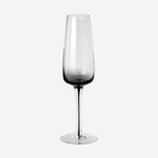 The Broste Copenhagen Champagne Glass in Smoke on a blank background