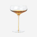 The Broste Copenhagen Cocktail Glass in Amber on a blank background