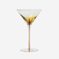 The Broste Copenhagen Martini Glass in Amber on a blank background