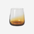 The Broste Copenhagen Short Tumbler Glass in Amber on a blank background