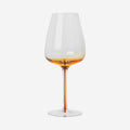The Broste Copenhagen White Wine Glass in Amber on a blank background