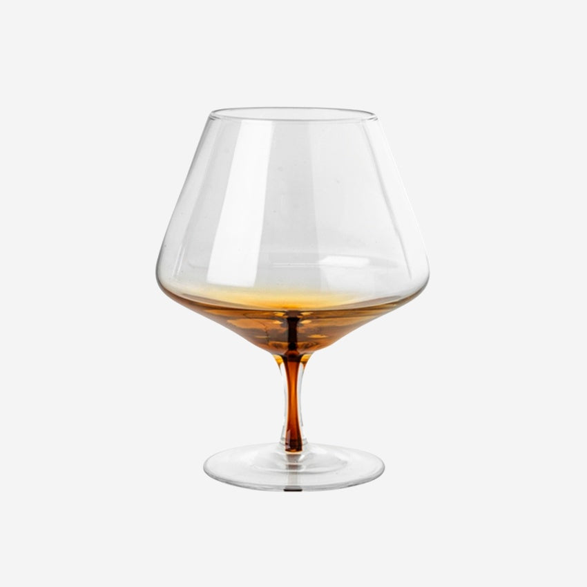 The Broste Copenhagen Cognac Glass in Amber on a blank background