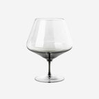 The Broste Copenhagen Cognac Glass in Smoke on a blank background