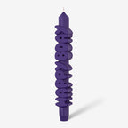 The CandleHand Happy Bday Taper Candle in purple on a grey background
