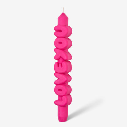 The CandleHand Love You 3D Taper Candle in pink on a grey background