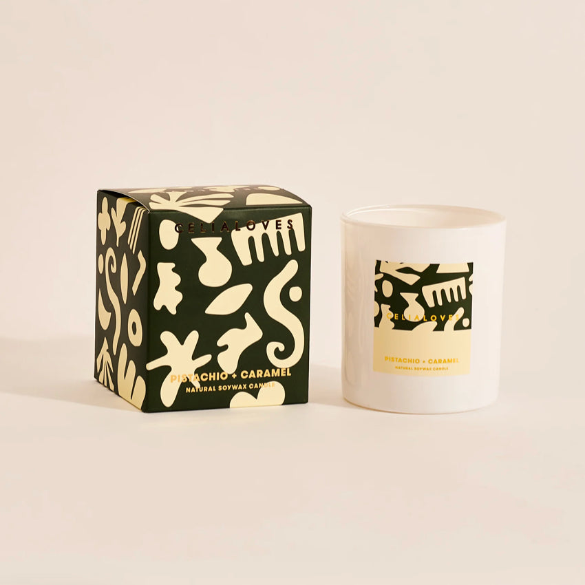 The Celia Loves Pistachio and Caramel Candle with its box