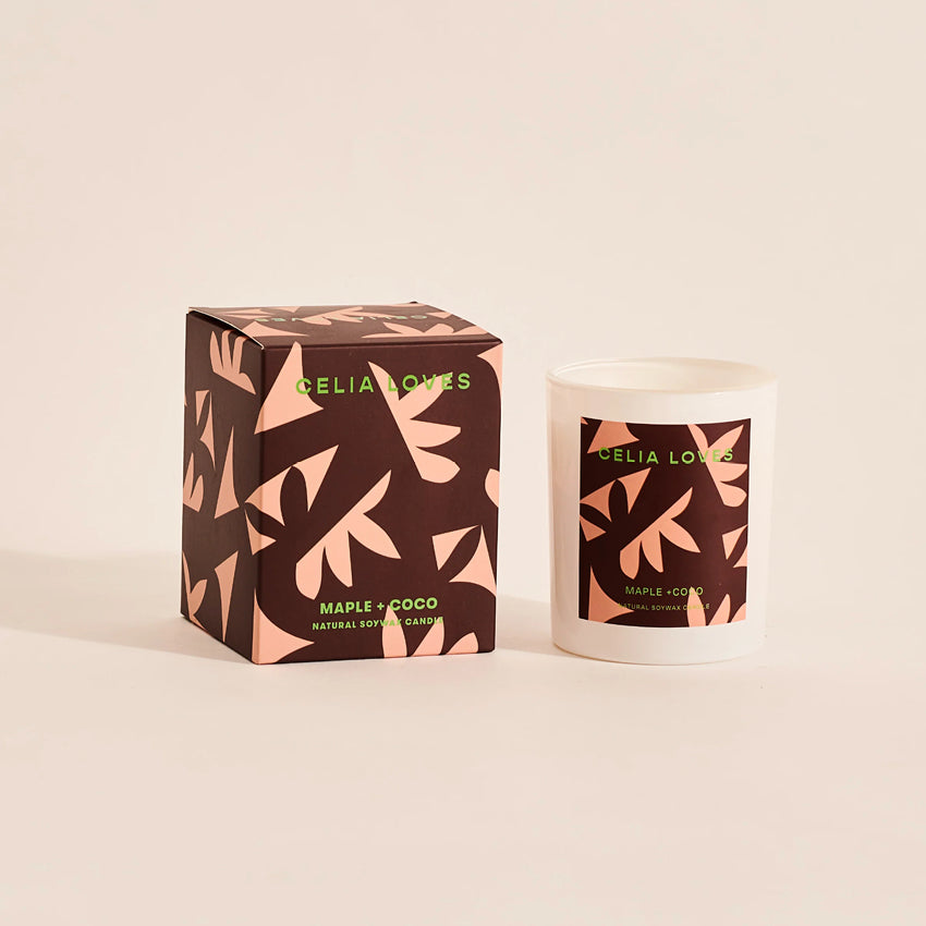 The Celia Loves Maple and Coco Candle with its box