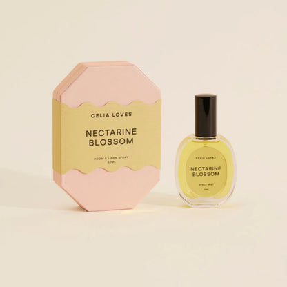 The Celia Loves Nectarine Blossom Room and Linen Spray with it's box on a blank background