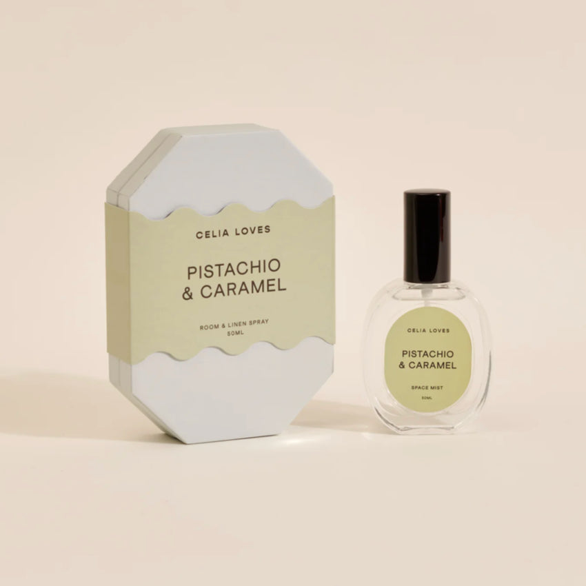 The Celia Loves Pistachio and Caramel Room and Linen Spray with it's box on a blank background