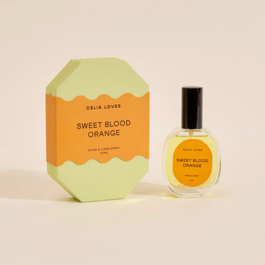 The Celia Loves Sweet Blood Orange Room and Linen Spray with it's box on a blank background