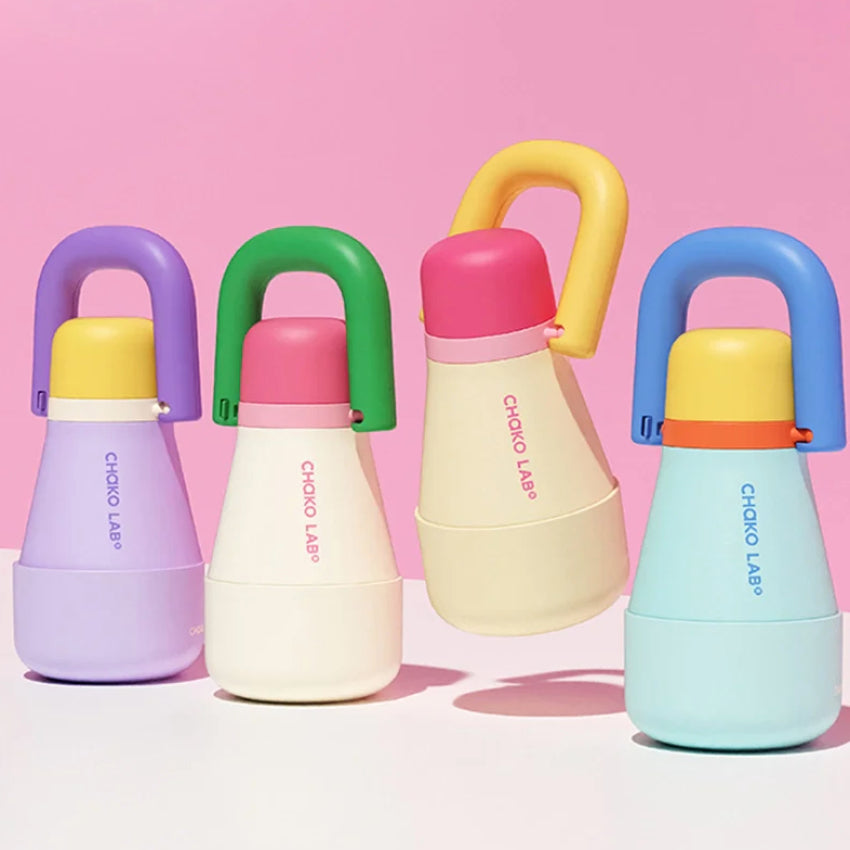 The Chako Lab Tata Thermos Cup in a range of colours on a pink background