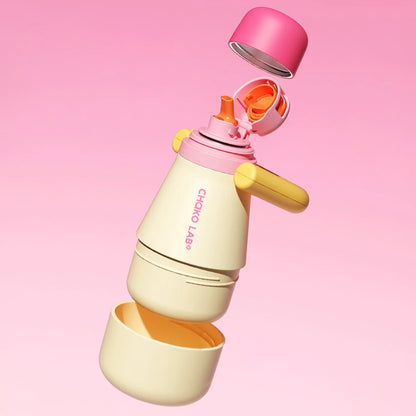 The Chako Lab Tata Thermo with the caps and cup unscrewed in yellow and pink on a pink background
