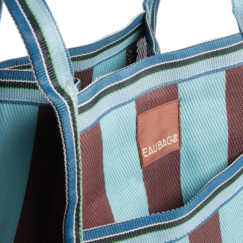 A close up of the EAU Sac Bag in Iced Chocolate on a grey background