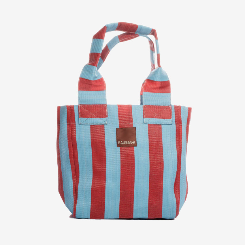 The EAU Tote Bag in Club Rouge on a grey background