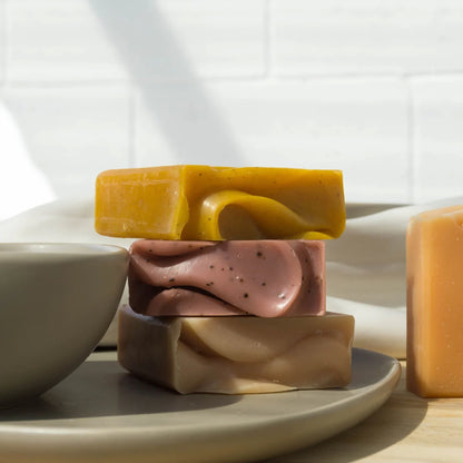 Three of the Fair + Square Soap Bars stacked on a plate