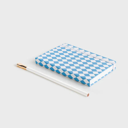 The Father Rabbit Hardcover Notebook in Blue Diamonds on a desk with a pencil