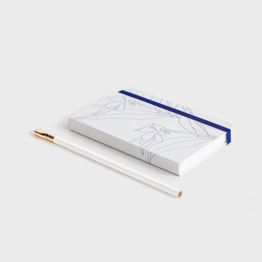 The Father Rabbit Hardcover Notebook in Blue Jasmine on a desk with a pencil