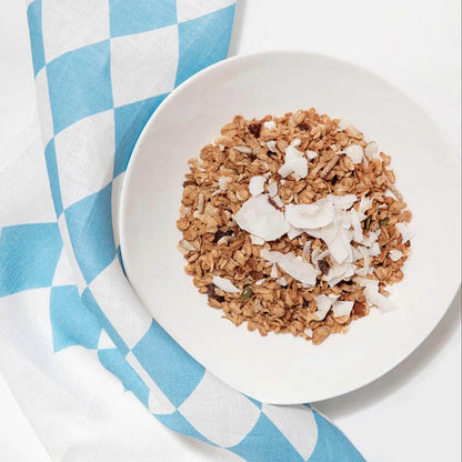 The Father Rabbit Tea Towel in Lemon Stripe with a bowl of muesli on it