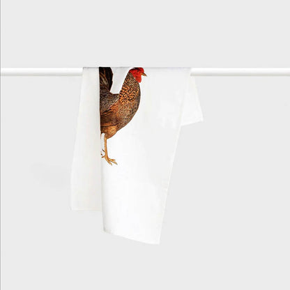 The Father Rabbit Tea Towel in Rooster design folded hanging on a rod on a blank background