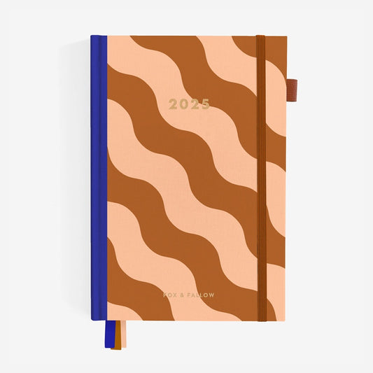 The Fox & Fallow 2025 A5 Horizontal Planner in Rust Swirl cover on a blank background.