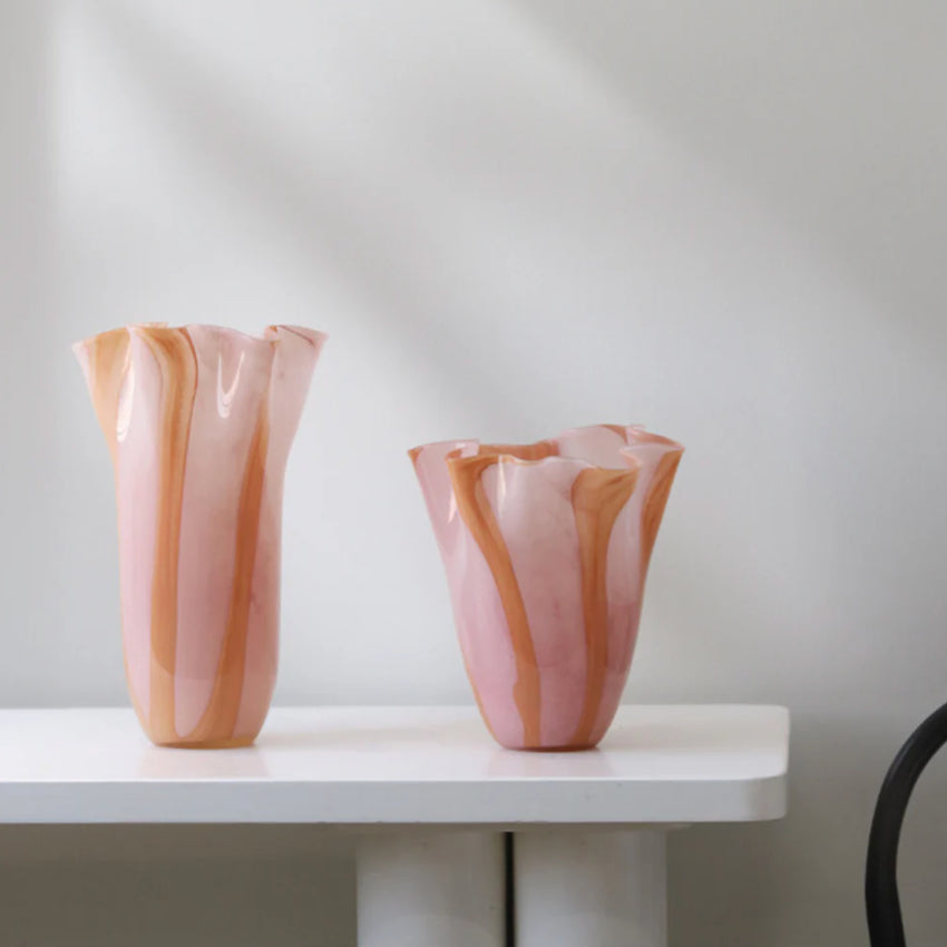 The medium and large Garcia Ruby Glass Jar on a bench 