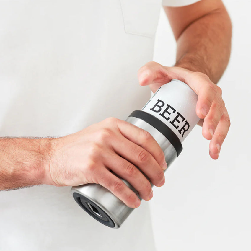 A guy putting a beer can in the Huski Beer Cooler in Stainless Steel 