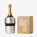 The Huski Champagne Cooler in Stainless Steel with a champagne bottle in it next to its box on a blank background