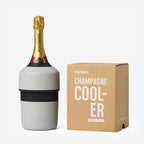 The Huski Champagne Cooler in Stone Grey with a champagne bottle in it next to its box on a blank background