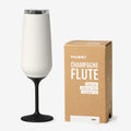 The Huski Champagne Flute in White next to its box on a blank background