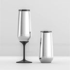 Two of the Huski Champagne Flutes in Stainless Steel, one with the stem on a one without on a blank background