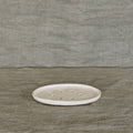 The JS Ceramics Soap Dish in Oatmeal on a green linen backdrop