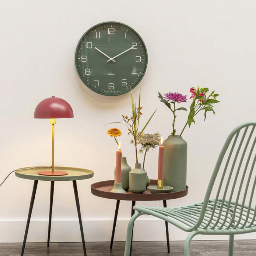 The Karlsson Lofty Wall Clock in Matte Greenon the wall above side tables