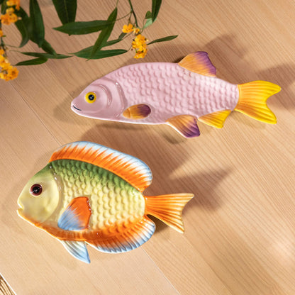 The &Klevering Rainbow and Snapper Fish Plates on a wood table