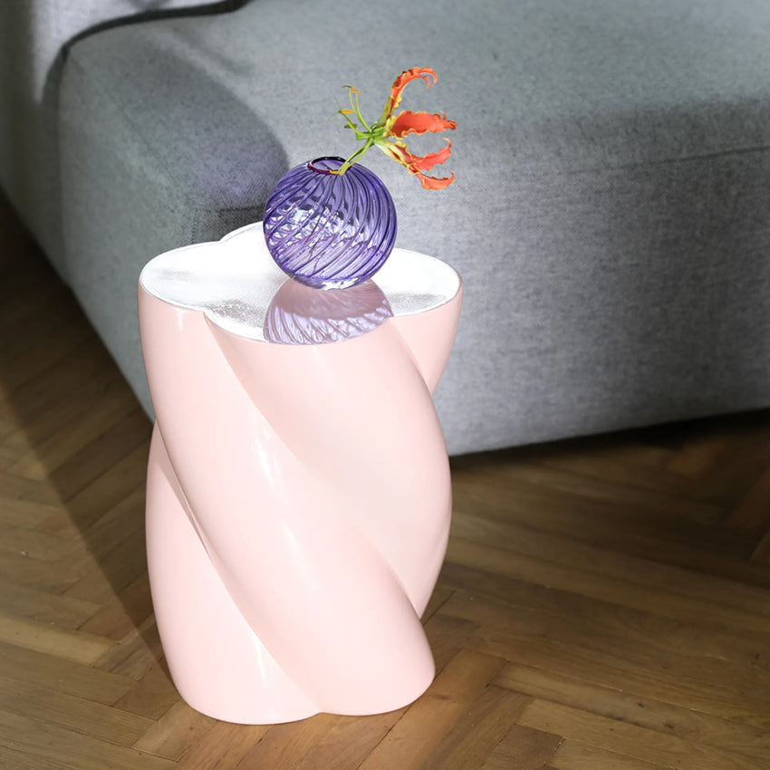 The &Klevering Marshmallow Pillar in Pink next to a couch on wood flooring with a vase on it