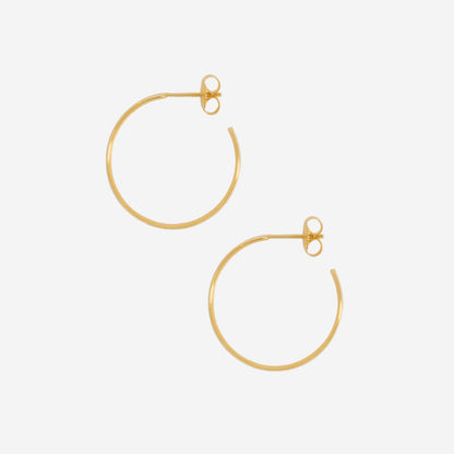 The La Tribe Large Curl Hoops in Gold on a blank background