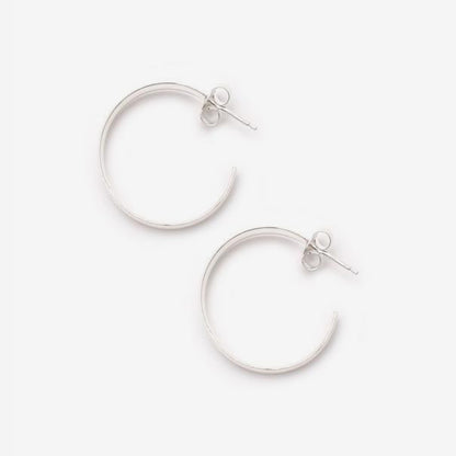 The La Tribe Large Curl Hoops in Silver on a blank background