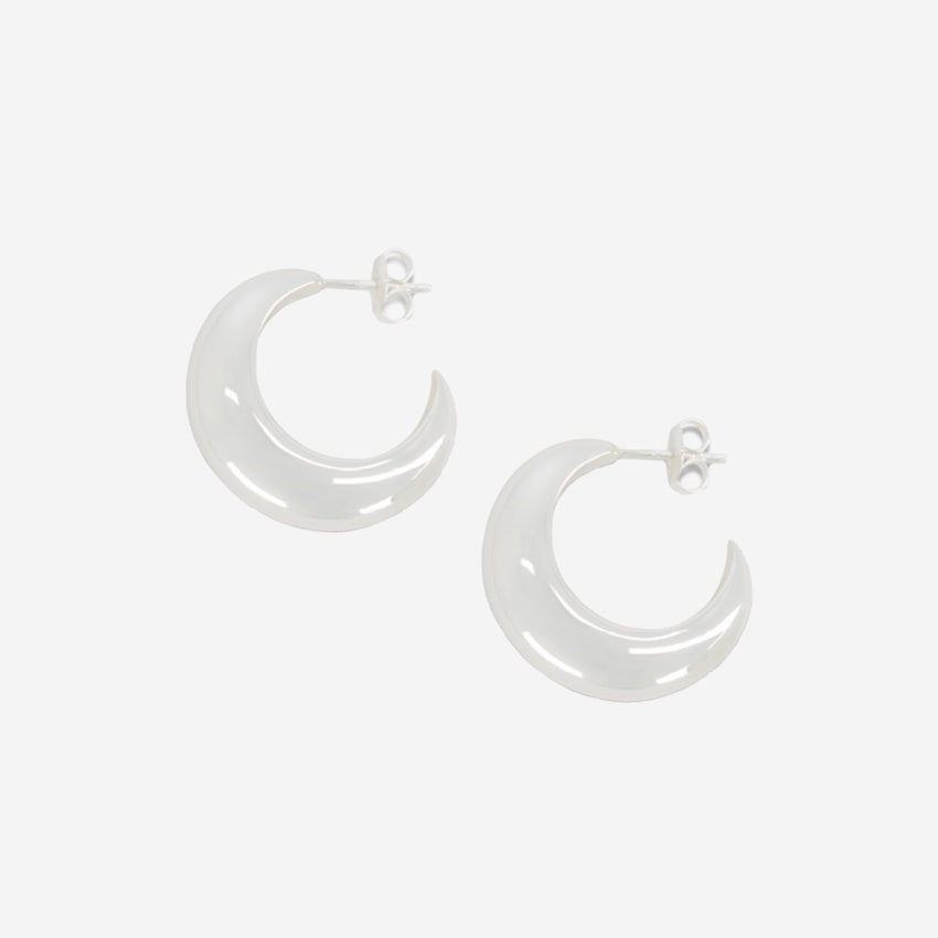 The La Tribe Half Moon Hoops in Silver on a blank background