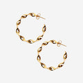 The La Tribe Large Twisted Hoops in Gold on a blank background