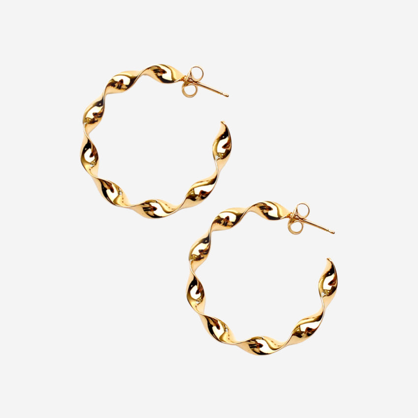 The La Tribe Large Twisted Hoops in Gold on a blank background