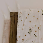 A closeup of the Leni The Label Muslin Cloth Set of 3 in Daisy