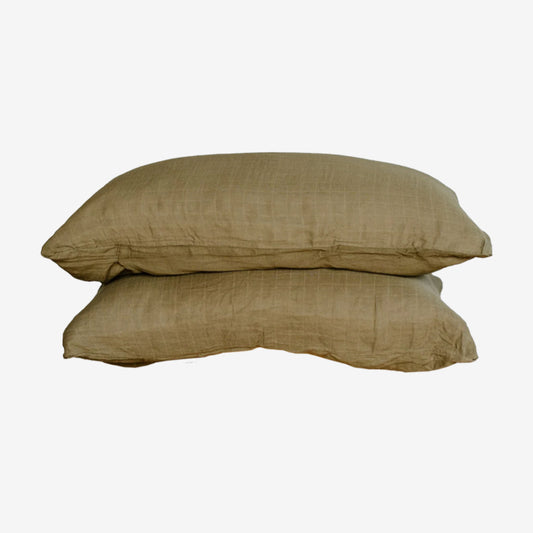 Leni The Label Muslin Pillowcases in Olive stacked on a blank background