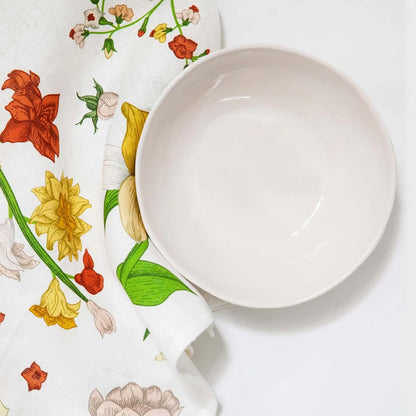 The Lettuce Linen Tea Towel in Vintage Wallpaper under a white bowl