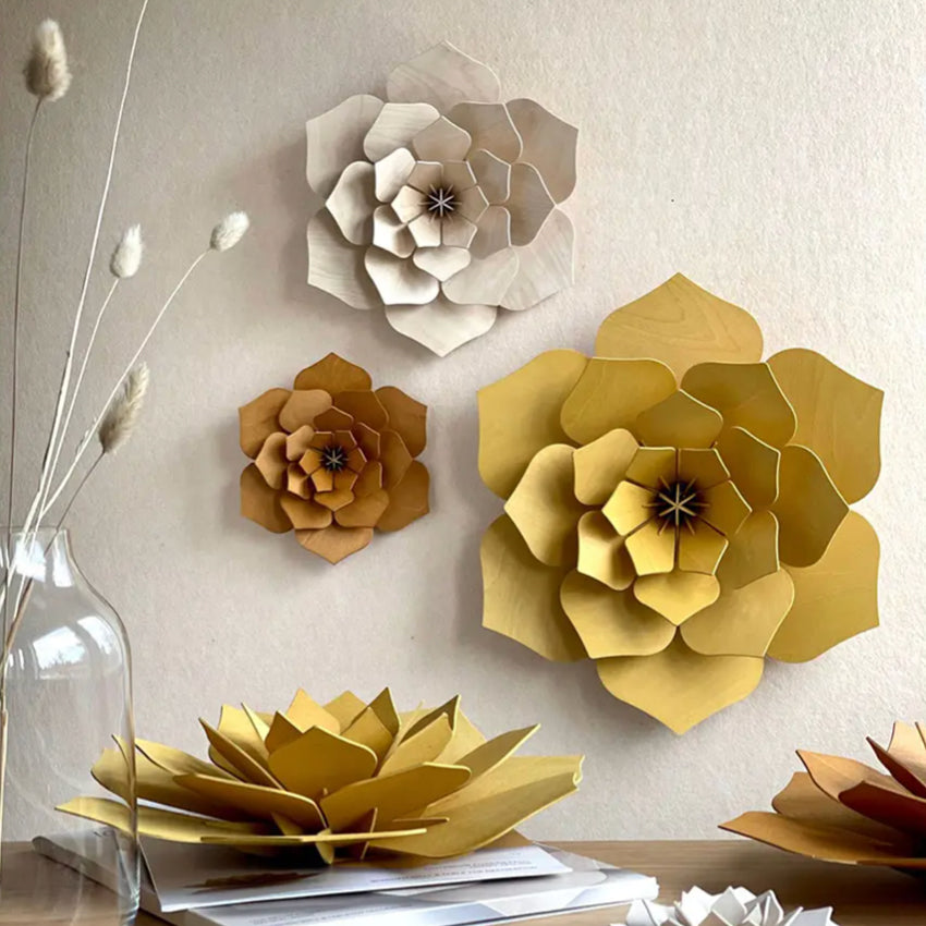 The Lovi 3D Flower Decor in Cinnamon hanging on a wall with other coloured Lovi 3D Flowers