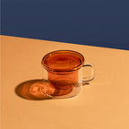 The Maho Cha For One Mug in Amber on a duo tone background