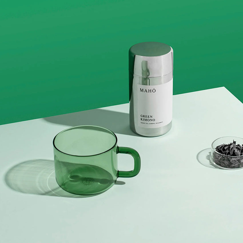 The Maho Cha Mug in Green next to the Maho loose leaf tea