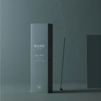 The Maho Gypsy Wood Sensory Sticks on a teal background