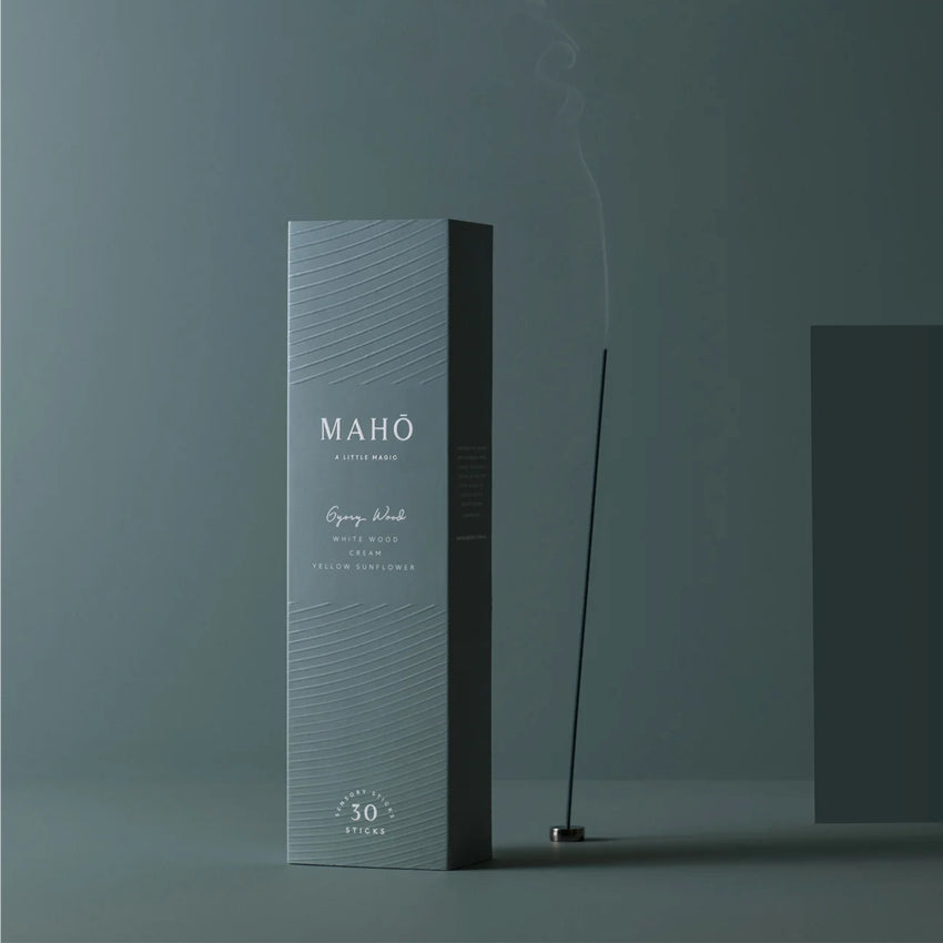 The Maho Gypsy Wood Sensory Sticks on a teal background